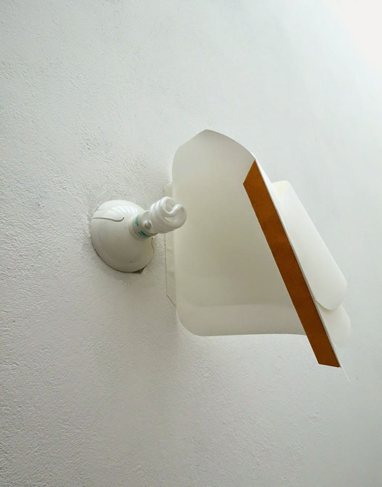 placing paper lamp on the wall