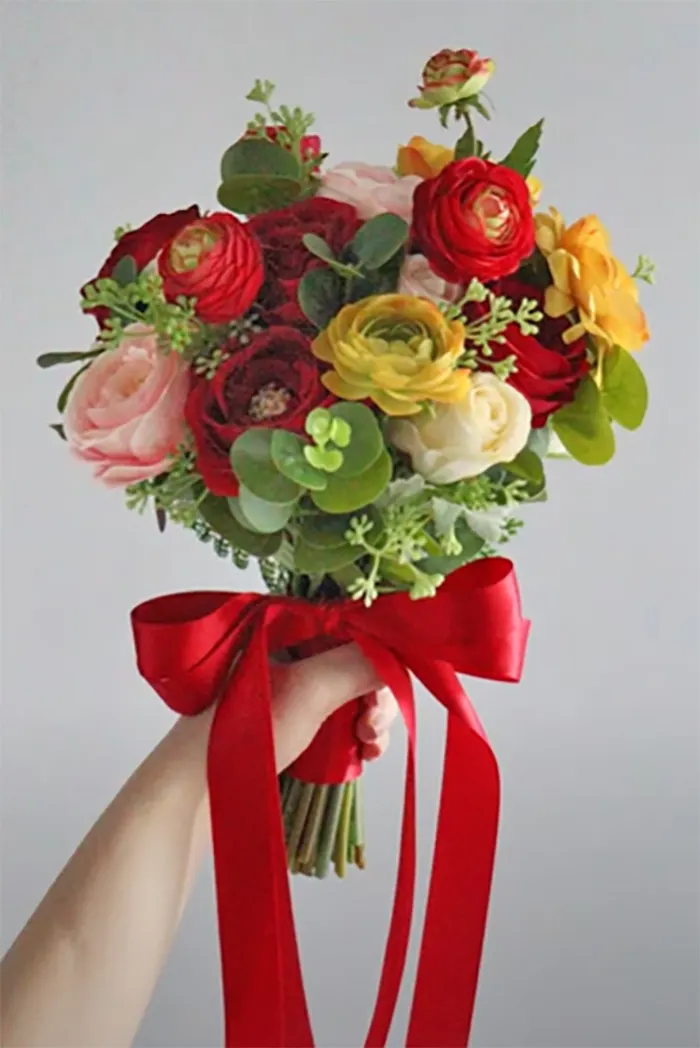 Florist Making A Red Roses Bouquet Wrapping In Kraft Paper On A